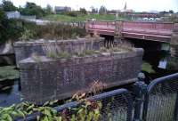 A forgotten main line perhaps? Hardly. These robust piers carried sidings from the Leicester and Swannington Railway over the River Soar towards the Great Central (the white semi-circles in the right background are arches under Central station). The sidings actually passed under the GC, but stopped short of the Midland. This view in September 2012 seems to have been opened up by demolition - I remember a splendid Victorian building on the far side of the river, with external plumbing - a prototype for the Pompidou Centre in Paris, perhaps.<br><br>[Ken Strachan 09/09/2012]