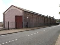 The East end of the restored Hood Road Good Shed in Barry, with the access road to the former 88C Barry MPD continuing forward beyond the building. [See image 40325].<br><br>[David Pesterfield 12/09/2012]