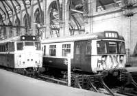 View over the buffer stops at Kings Cross in 1981. On the left 31405 has brought in empty stock, while alongside is emu 312708 with a recent arrival from Royston. <br><br>[John Furnevel 13/01/1981]