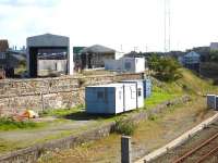 View south towards Holyhead TMD from the bridge parapet opposite the station access road in September 2012. The HST fuelling point is nearest the camera with the two road servicing shed beyond. The RH road is not used at present. The signal box stands on the banking alongside the depot.<br><br>[David Pesterfield 05/09/2012]