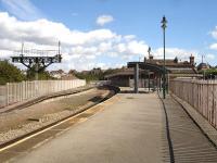 Barry Island station looking east in 2012, now comprising a single bay platform. A crossover bridge has been created to give access to Barry Steam Railway's Plymouth Road station, seen in the left background. Barry Island station building is now used by Cambrian Transport, the new operators of Barry Steam Railway.<br><br>[David Pesterfield 11/09/2012]