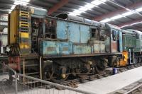 Shunter 08628 was bought by the Ribble Steam Railway with a view to restoration followed by deployment on the Bitumen Tanker trains and passenger services. However, it became clear that repairs would be a long and very expensive process and, as other similar locos in working order were scheduled to arrive, it was stripped for spares and breaking. The former D3795, withdrawn from Bescot in 1999, is seen here inside the RSR running shed for component recovery in July 2012. [See image 52838]<br><br>[Mark Bartlett 15/07/2012]