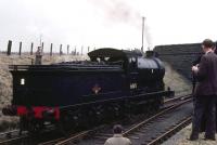 Running round 'Scottish Rambler No 3' at Kingsmuir on the Dundee - Forfar direct line on 28 March 1964. J37 0-6-0 no 64618 from Thornton Junction handled this section of the tour which took in local branch lines around Dundee.<br><br>[Andy Carr Collection 28/03/1964]