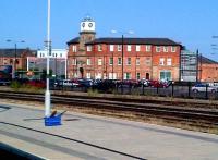 The entrance building is one of the few remaining parts of the Midland's Derby Works, and one of the few which can be seen from the station. The building, seen here in September 2012, has been renovated and updated with modern extras: truly 'old meets new'. Notice the high-tech wash equipment on the platform.<br><br>[Ken Strachan 15/09/2012]