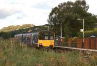 A Manchester Victoria to Clitheroe service drifts to a halt at Langho station in Lancashire's Ribble Valley on 29 September 2012. The platforms here are staggered and the train is passing the southbound platform approaching the northbound one.<br><br>[John McIntyre 29/09/2012]