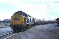 The 09.38 train of Esso bogie tankers from Bowling has almost reached its destination on 26 May 1970 as EE Type 3 No. 6850 brings it cautiously across the Granton harbour access road. <br><br>[Bill Jamieson 26/05/1970]