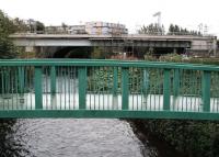 Shortly after leaving Murrayfield, westbound trams will cross the Water of Leith on another new bridge. That bridge is seen here on 14 October 2012 with construction work well advanced. View is south east, with the catenary of the E&G main line standing just beyond and new flats on Westfield Avenue in the background. [See image 48077]  <br><br>[John Furnevel 14/10/2012]