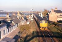 The low evening sun provides no hiding place for the photographer's silhouette as the 17.00 Inverness-Wick/Thurso powers away from Clachnaharry swing bridge in October 1972.<br><br>[Frank Spaven Collection (Courtesy David Spaven) /10/1972]