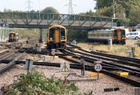 A trio of Southwest Trains Class 159s at the east end of Basingstoke station on 23 September 2011. In the centre a Waterloo to Salisbury service approaches the station while another unit waits in the sidings on the left and a six car set is in the long grass on the right.<br><br>[John McIntyre 23/09/2011]