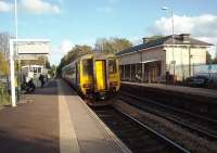 A Liverpool to Huddersfield stopping service, formed by Northern 156483, calls at Huyton. On the opposite platform the original Liverpool and Manchester Railway station building, probably dating from soon after 1832 when Huyton opened, is still in use and staffed. Just beyond the train the signal controls the junction with the St Helens Central line but this service will go straight on for Manchester.  <br><br>[Mark Bartlett 17/10/2012]