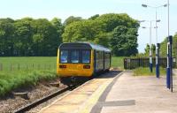 View west along the deserted platform at Salwick on 22 May 2012 as 142035 passes through heading for Blackpool North.<br><br>[John McIntyre 22/05/2012]