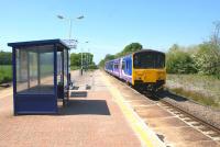 A Northern service from Blackpool South to Colne rushes through Salwick towards Preston on 22 May 2012. Today there are only 2 tracks here but at one time there were two more on the right running between Preston and Kirkham.<br><br>[John McIntyre 22/05/2012]