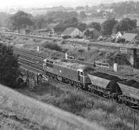 The closure of the Woodhead route in July 1981 resulted in the South Yorkshire to Fiddler's Ferry power station MGR coal traffic being rerouted via Mirfield and Standedge. On a glorious evening almost exactly two years after Woodhead had closed, No. 56017 passes Heaton Lodge, just west of Mirfield, with a westbound loaded train.<br><br>[Bill Jamieson 22/07/1983]