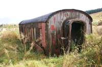 Near Rhynie on the A941 road to Dufftown in October 2012 is this grounded coach body. It has seen better days and there are a few bits missing but what appears to be the original corridor connection is still in place. How long it has been here and how it was transported here are not known. At one time there were many coaches reused in this way on the farms in the north-east but since an earlier visit to the area some 35 years ago the numbers have reduced considerably.<br><br>[Notes and Queries 14/10/2012]