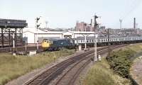 A sparkling BRCW 1250 hp Type 2 No. 5404 passes Haymarket Central Junction in June 1971 with a Sunday push-pull service to Glasgow Queen Street. Another Type 2 brings up the rear of the train. Haymarket shed stands on the north side of the E&G with the line in the foreground joining the 'sub' at Gorgie Junction [see image 36277].<br><br>[Bill Jamieson 07/06/1971]