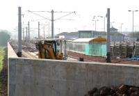 View south east over the retaining wall around Edinburgh Airport's new tram terminus on 21 October 2012. Track is now in place, including a crossover beyond the island platform, with associated works looking well advanced. The Gogar Burn runs past just off picture to the left. [See image 40723]<br><br>[John Furnevel 21/10/2012]