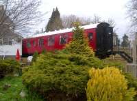 The purist might object that this carriage is not just the wrong colour, but also some 15 metres across from, and 4 metres up from, the trackbed of the Bristol and North Somerset Railway, in the garden of the Station Hotel. The purist might just miss out on a good lunch!<br><br>[Ken Strachan 06/04/2012]