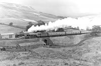 <h4><a href='/locations/G/Garsdale'>Garsdale</a></h4><p><small><a href='/companies/S/Settle_and_Carlisle_Line_Midland_Railway'>Settle and Carlisle Line (Midland Railway)</a></small></p><p>Following a stop at Dent, <I>Flying Scotsman</I> is pictured making for Appleby with 'The Lord Bishop' special on 30 September 1978. Scene approximately a mile and a half north of Garsdale. 59/132</p><p>30/09/1978<br><small><a href='/contributors/Bill_Jamieson'>Bill Jamieson</a></small></p>