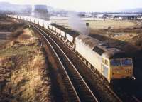 A well-loaded Speedlink service heads south from Inverness in early February 1986, conveying 5 HEAs of imported coal from Invergordon, 8 Scottish Malt Distillers empty barley hoppers, several empty LPG tankers, empty coal containers ...and a partridge etc.<br><br>[Frank Spaven Collection (Courtesy David Spaven) /02/1986]