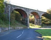 In 1878 a goods line was completed linking the yard on the east side of the ECML at Tweedmouth station with the recently opened Tweed Dock. The steeply graded zig-zag route was eventually closed during the 1960s and most of the former branch is now a public walkway. The most significant surviving structure is a viaduct which now forms part of that walkway, seen here in October 2012 looking north west along Dock Road. [See image 40885]<br><br>[John Furnevel 07/10/2012]