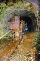 A view looking into the Cononish gold mine, south of Tyndrum, through the security grill. A short section of partly dismantled track runs to sheds and the spoil tip. The lines describe a triangle.<br><br>[Ewan Crawford 13/10/2012]