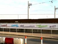 <I>'And now - a message from our sponsor....'</I>  Banner running alongside the under-construction tram terminus at Edinburgh Airport on 21 October 2012. <br><br>[John Furnevel 21/10/2012]