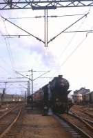 A splendidly turned-out steam locomotive shunts electric locos in the sidings alongside Zagreb station on 13th September 1972.<br><br>[David Spaven 13/09/1972]