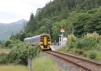 The small request stop at Attadale, near the shore of Loch Carron, often sees trains passing straight through but on this occasion 158707 has stopped to allow passengers to alight. The Class 158 is on an Inverness to Kyle of Lochalsh service. <br><br>[Mark Bartlett 11/07/2012]