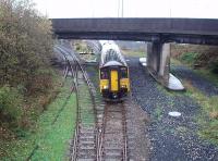 150228 has just met the Isle of Man sailing and now departs with the daily 1315 Heysham Port to Leeds service on a very wet November day. The Sprinter is just passing the ground frame that controls access to Heysham Power Station. [See image 37885] for the view of the port itself from the bridge shown here.  <br><br>[Mark Bartlett 09/11/2012]