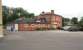 What was once Northallerton Town station, opened by the Leeds Northern Railway in June 1852 and closed less than 4 years later on 1 January 1856. Low Gates level crossing and signal box on the Northallerton - Teesside line can be seen on the north side of the A167 in the background, with the town's High Street off to the right. The refurbished and extended building, seen here in July 2012, is now a kitchen showroom. <br><br>[John Furnevel 09/07/2012]