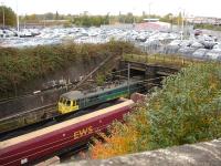 86610 coupled to 86604 enters the low level avoiding line tunnel running below the former 5A Crewe North shed site on 25 October. Alongside is a loaded EWS coal train waiting for the road towards Basford Hall.<br><br>[David Pesterfield 25/10/2012]