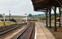 Looking along the down platform at Hellifield on 21 June 1975. Class 47 No. 47473 is approaching the station from the north with a short train of four wheel oil tanks.<br><br>[Bill Jamieson 21/06/1975]