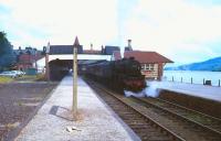 BR days at Lakeside. Stanier Black 5 4-6-0 no 45394 awaiting its departure time at Lakeside station in 1965 with a train for Ulverston and Barrow. This was the final year of BR operations over the branch. Lake Windermere can be seen stretching away to the north.<br><br>[Robin Barbour Collection (Courtesy Bruce McCartney) //1965]