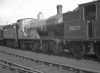 Locomotive lineup at Eastleigh shed in 1962 featuring Drummond T9 'Greyhound' 4-4-0 no 120 (30120), outshopped from Eastleigh Works 6 months earlier in LSWR green livery. It was officially withdrawn by BR at the end of July 1963 and is now preserved as part of the national collection. The locomotive is currently on loan to the Bodmin and Wenford Railway [see image 21111].<br><br>[K A Gray 30/10/1962]