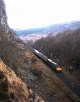 Bird's-eye view of a Kyle of Lochalsh - Inverness train at Ravens Rock summit, west of Achterneed, in the 1970s.<br><br>[Frank Spaven Collection (Courtesy David Spaven) //]