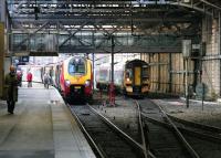 Prior to the 2006 reorganisation at Waverley the long north side through platform was designated 1 & 19.  In October 2005 a Bathgate - Newcraighall train is in the process of running into platform 1, after bypassing a Virgin Voyager for Plymouth, currently boarding at platform 19. Above the trains is the footbridge linking the station with Waverley Steps, also replaced during the works [see image 9661].<br><br>[John Furnevel 12/10/2005]