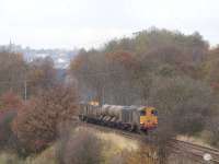 The West and South Yorkshire section of the Network Rail RHTT operation sees 20303 leading the set towards Barnsley on 14 November with 20312 at the rear. The train is passing the site of Crigglestone Junction signalbox which stood to the left of the line here. A section of the Midland Railway viaduct at Calder Grove on the Thornhill to Notton branch can be seen through the gap in the trees. [See image 28049] for a similar view almost 40 years earlier.<br><br>[David Pesterfield 14/11/2012]