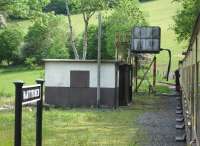 The water tank at Nantyronen on the Vale of Rheidol line, used to replenish locomotives on the very demanding rising gradient when working towards Devils Bridge from Aberystwyth, seen here from a train on 30 May 2012. <br><br>[David Pesterfield 30/05/2012]