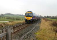 The 1402 Windermere to Manchester Airport only calls at Kendal on the branch and 185105 is seen here having just passed over Staveley level crossing at speed on 16 November. The formerly double track line now enjoys a basically hourly TPE service and far more trains than in steam days.<br><br>[Mark Bartlett 16/11/2012]