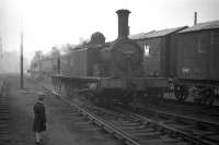 The 'wee Gorgie pilot' J88 No. 68335 shunts Gorgie East goods yard in 1961. The unusual peaked-roof wagons conveyed grain from Leith Docks to the North British Distillery sidings, just north of Gorgie East - this large grain distillery is still in business, although the rail connection is long gone.<br><br>[Frank Spaven Collection (Courtesy David Spaven) //1961]