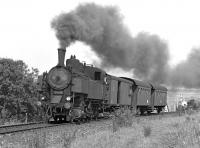 Any efficiency gains from the fitting of a Giesl ejector are not obvious as lightweight 2-8-2T No. 93.1322 makes a smoky start out of Schwarzenau along the single track line from Vienna with the 14.10 departure to Gmnd in September 1975. <br><br>[Bill Jamieson 09/09/1975]