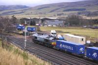 Containers from the Highland Spring plant (in the background) being loaded at Blackford on 20 November [see image 41094]. Due to the lack of run round facilities here, 66427 will take the train to Perth where it will reverse before heading for Coatbridge FLT.<br><br>[Bill Roberton 20/11/2012]