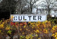 Not quite Gil Sans LNER lettering on the Culter Station platform sign. Original concrete posts poking through the autumn vegetation in November 2012.<br><br>[Brian Taylor 11/11/2012]