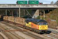 One of a few Class 56s that have been put into service in Colas Railfreight livery is 56094, seen here on the Carlisle to Chirk loaded log train on 27 October 2012 heading south along the WCML at Farington Junction.<br><br>[John McIntyre 27/10/2012]
