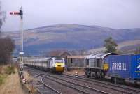 The 07.55 East Coast Inverness - London Kings Cross HST runs over the level crossing and through the site of  Blackford station on 20 November 2012. On the right DRS 66427 is preparing to take a trainload of containers from the Highland Spring bottling plant to Coatbridge FLT.<br>
<br><br>[Bill Roberton 20/11/2012]