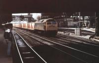 Early days on the Manchester waste trains and the driver of 47289 opens the throttle though Victoria station to tackle Platting Bank with a train of refuse containers in August 1982. This was long before the complete rebuild of the station [see image 32874]. 47289 lasted in service until 2003 and was only cut up in 2010 in Stockton.<br><br>[Mark Bartlett 26/08/1982]