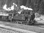 Could this be the most exotic steam type ever to feature on Railscot? 0-12-0RT No. 197.303 dating from 1912 waits to depart from the summit station at Prbichl on the rear of the combined 07.15 and 08.10 loaded workings from Erzberg in September 1975. 0-6-2RT No. 97.207 was at the front for the 8 km long descent to Vordernberg where electric power would take over for the remaining 13 km on easier grades to Donawitz steelworks.<br><br>[Bill Jamieson 06/09/1975]