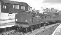 A train for Ryde stands at Cowes, Isle of Wight, on 16 August 1961. The locomotive is  Adams class O2 0-4-4T no 30 <I>'Shorwell'</I>. The 1862 station at Cowes closed in 1966 and, after being put to use as a car park for a number of years, a supermarket now stands on the site.<br><br>[K A Gray 16/08/1961]