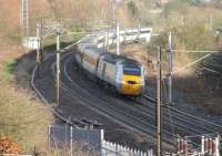 An East Coast HST, led by 43272, powers away from Durham heading south. The train is passing the site of Deerness Valley Junction where lines to Consett and Bishop Auckland left the ECML. After these lines closed the main line was realigned to ease an even sharper curve.<br><br>[Mark Bartlett 27/11/2012]