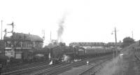 An unidentified Britannia Pacific restarts a northbound service from Carstairs, thought to have been photographed in mid-1965. The train is about to pass a Black 5 standing alongside Carstairs No 2 box.  <br><br>[K A Gray //1965]